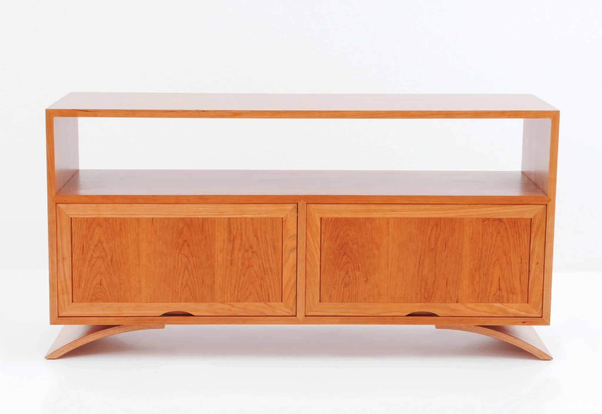 Credenza - The Credenza has two exposed surfaces for lamps, photographs, and reading materials with an enclosed storage